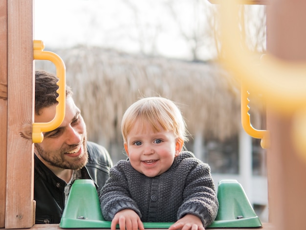 Free photo father and son on the playground