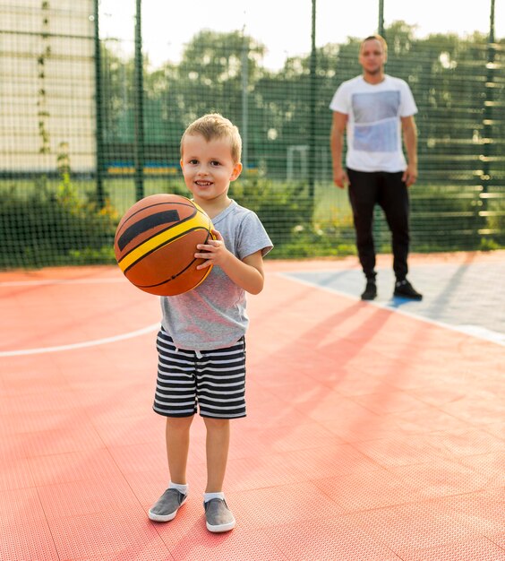 Father and son playing basketball