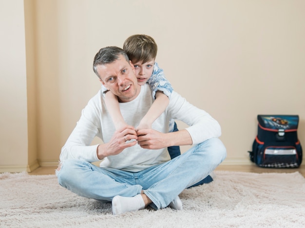 Father and son playing on the carpet