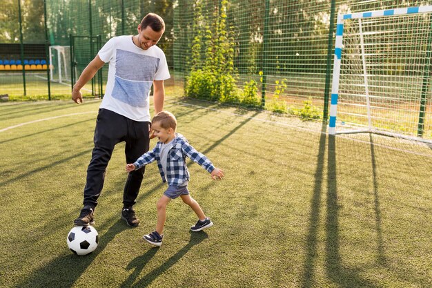 Father and son playing football