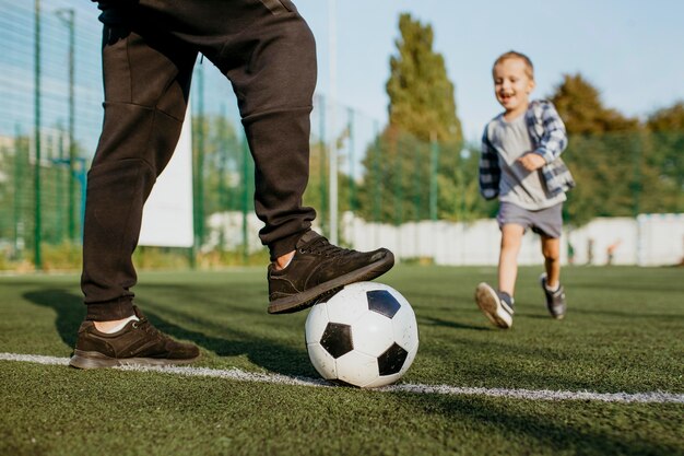 Father and son playing football