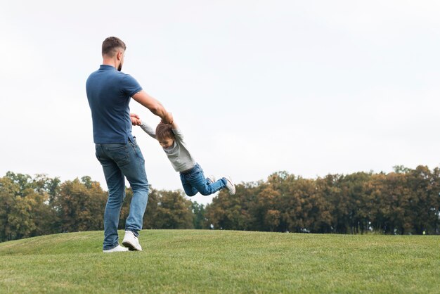 Father and son playing on the grass