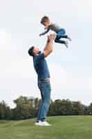 Free photo father and son playing in park