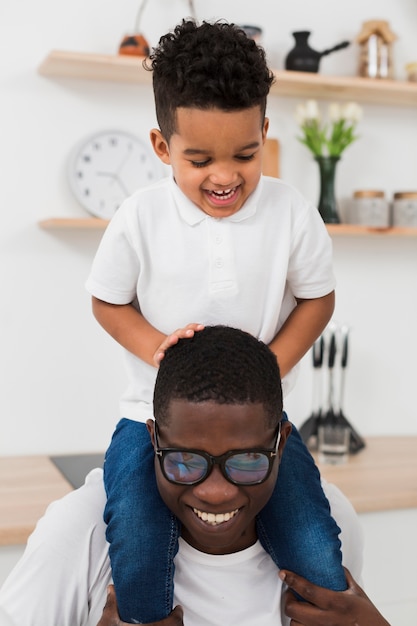 Father and son playing together in the kitchen