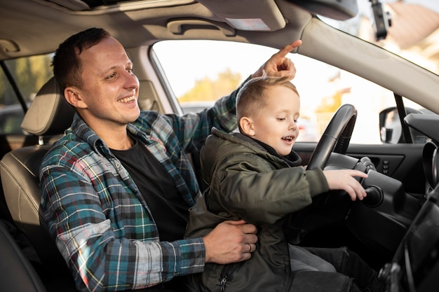 Father and son playing with the car wheel