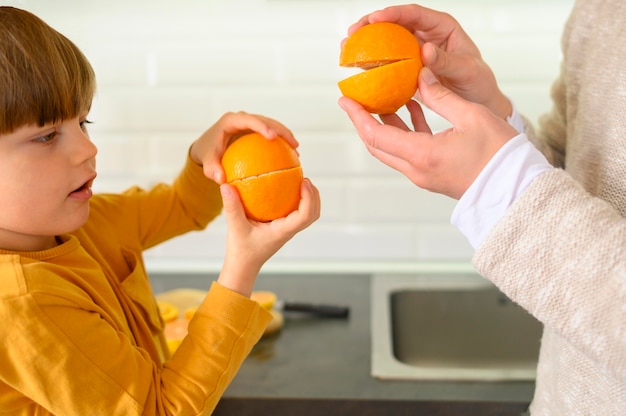 Father and son playing with oranges