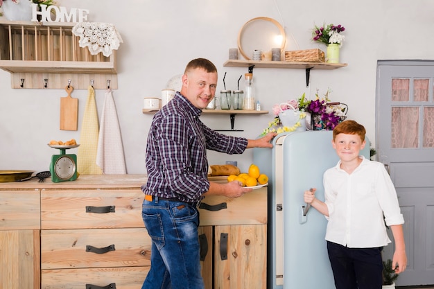 Father and son posing in the kitchen