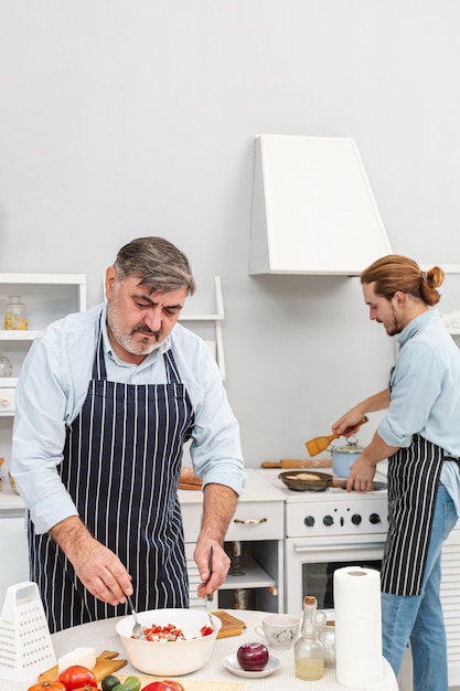 Father and son preparing delicious salad