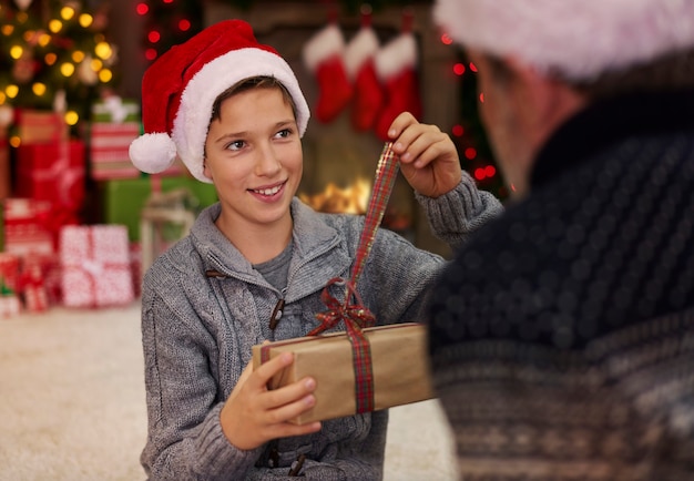 Free photo father and son in the surrounding of christmas atmosphere