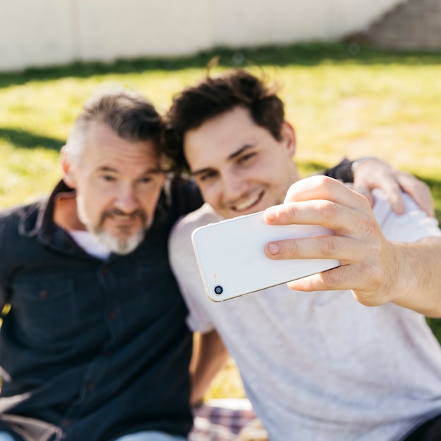 Free photo father and son taking selfie