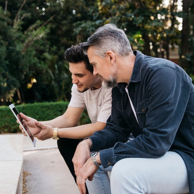 Father and son using tablet