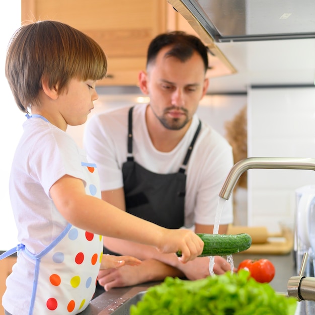 Father and son washing the cucumber