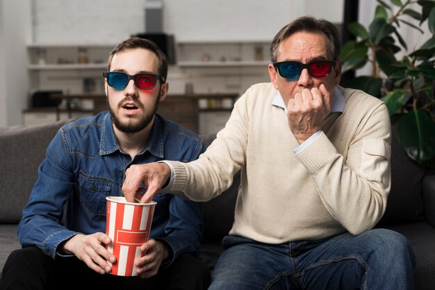 Father and son watching 3d movie