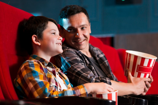 Father and son watching movie in cinema