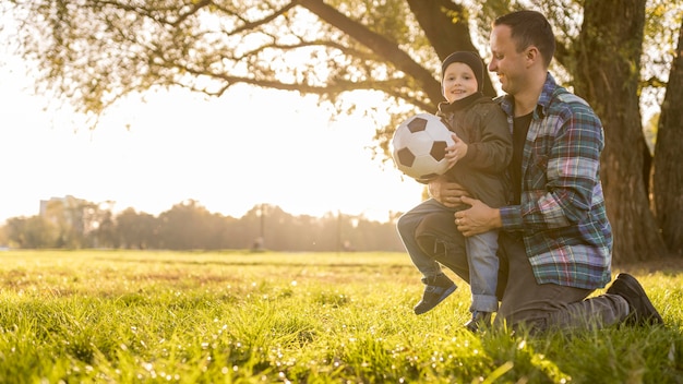 Father and son with a football long view