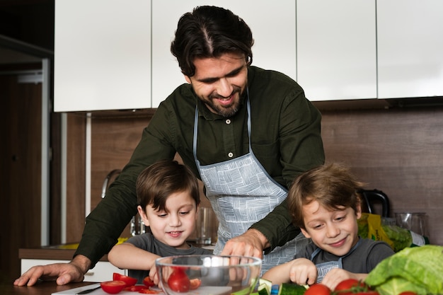 Free photo father and sons in the kitchen