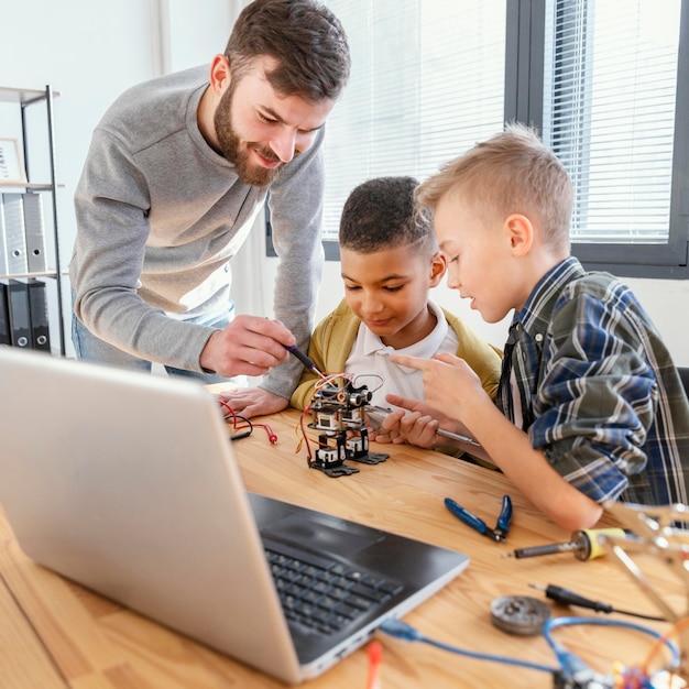 Father and sons making robot