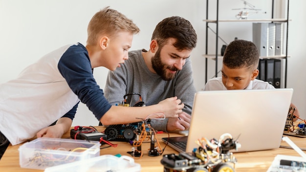 Father and sons making robot