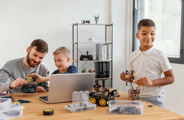 Father and sons making robot