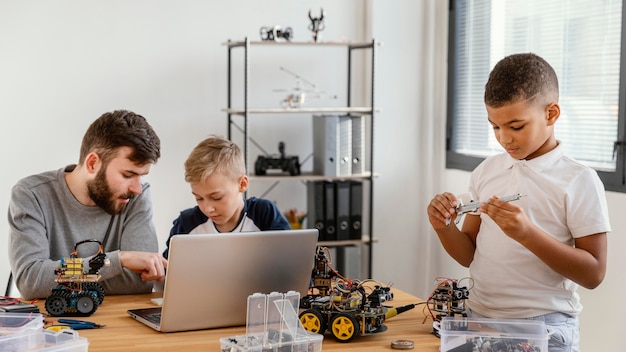 Father and sons making robot