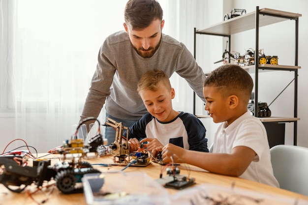 Father and sons making robot