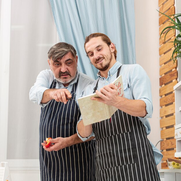 Father and soon checking a recipe