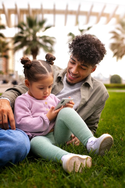 Free photo father spending time with his daughter outdoors on father's day