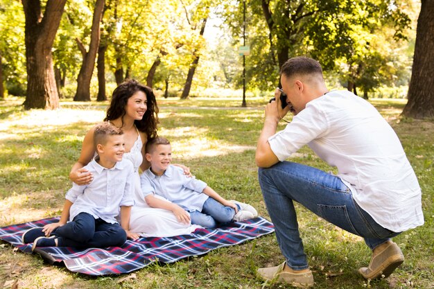 Father taking a photo of his family