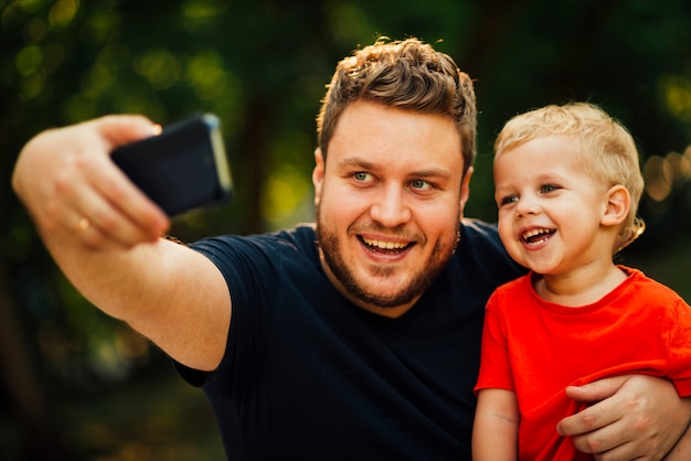 아버지는 그의 아들과 함께 selfie를 복용