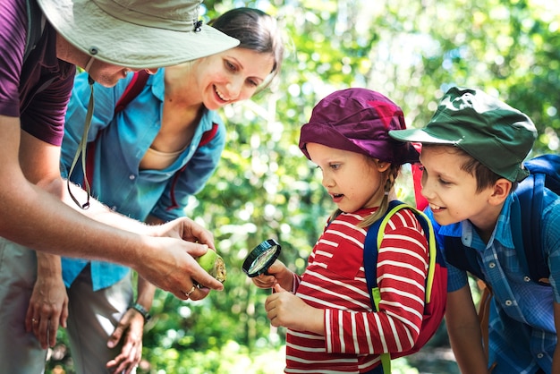 Father teaching his daughter how to use a magnifying glass