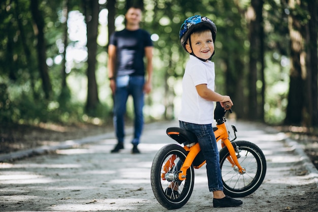 Father teaching his little son to ride a bicycle