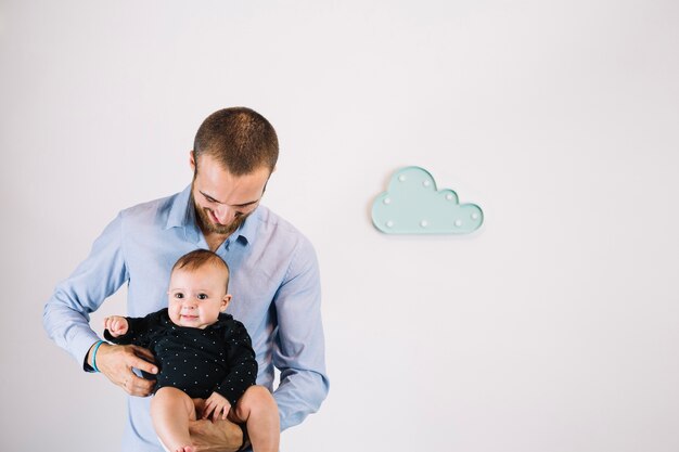 Father tickling baby