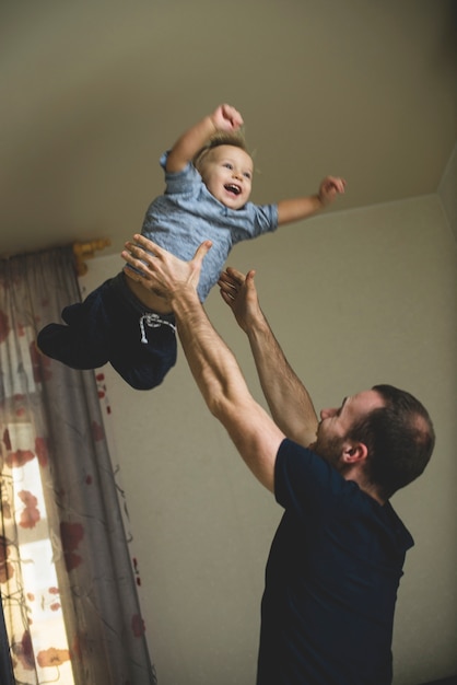 Father tossing his son into the air