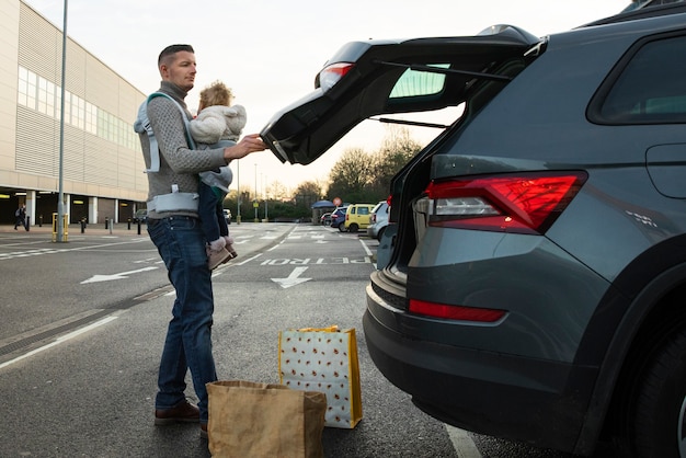 Father using a carries for his newborn baby while doing daily activities