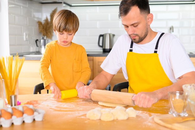 Father using the paddle on the dough