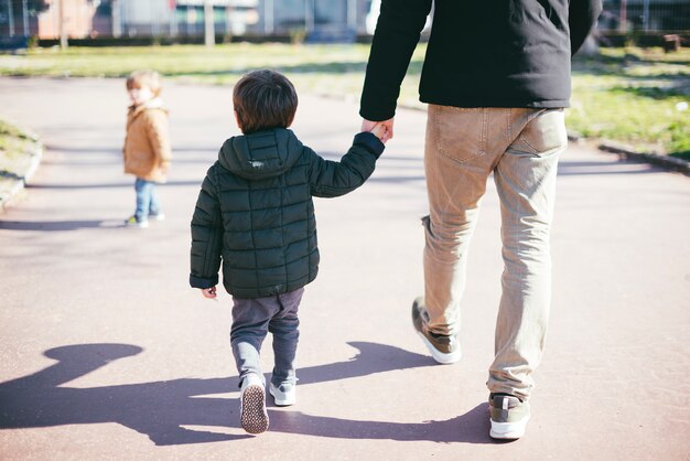 Father walking with son on street