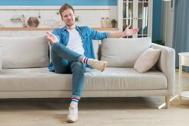 Father wearing casual clothes and sitting on couch