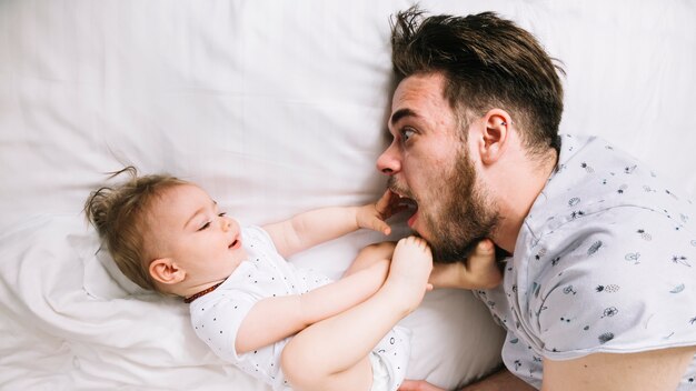 Father with baby in bed