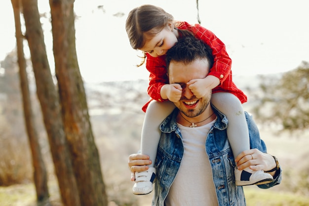 Free photo father with daughter in a forest