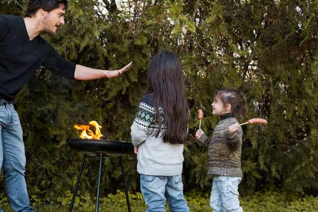 Father with her daughter enjoying near barbecue at outdoors