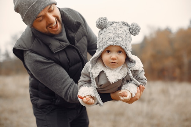 Father with little daughter playing in a spring field