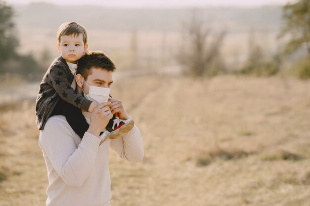 Father with little son wearing masks