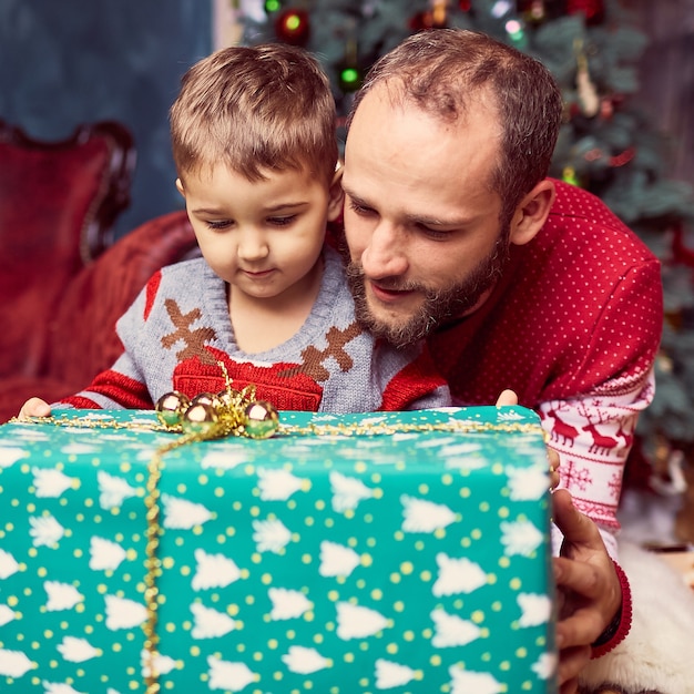 The father with son looking at present