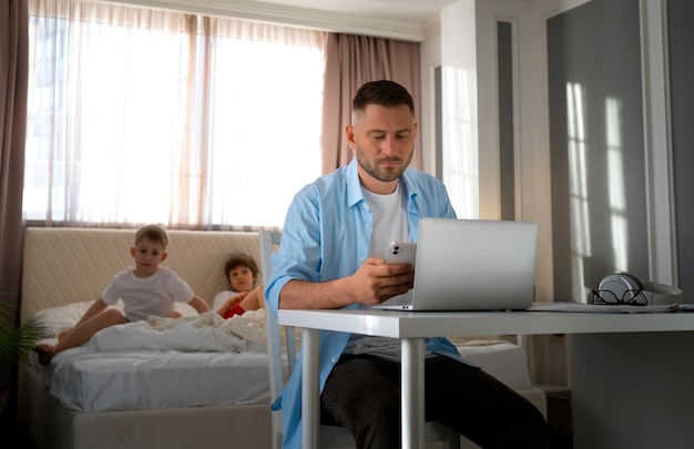 Father working from home trying to balance family life with child and job