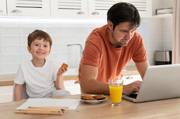 Father working remotely medium shot