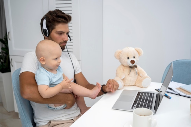 Father working with child during quarantine