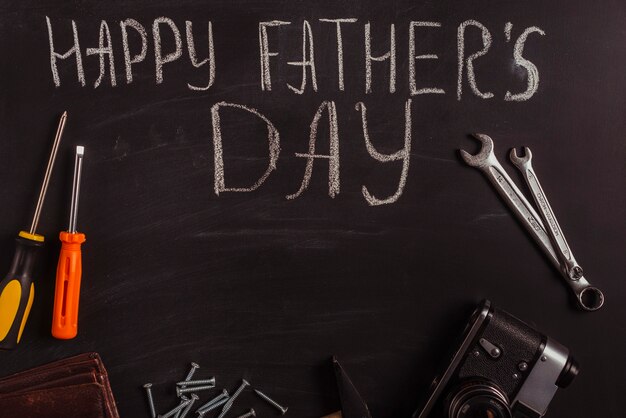 Fathers day composition on blackboard with tools