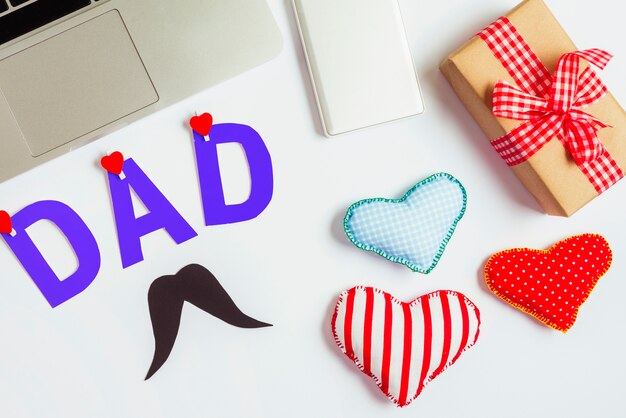 Fathers day composition with laptop and hearts