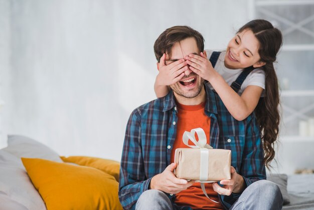 Fathers day concept with daughter covering fathers eyes