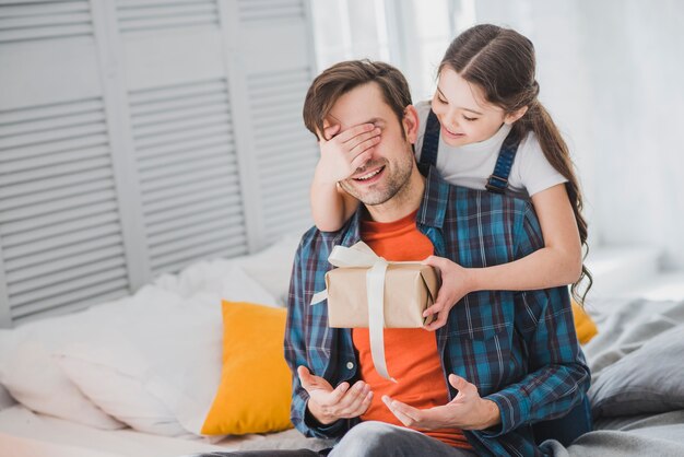 Fathers day concept with daughter covering fathers eyes